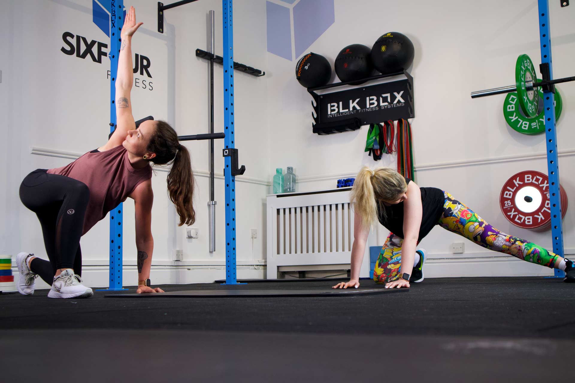 Two members stretching together after a class